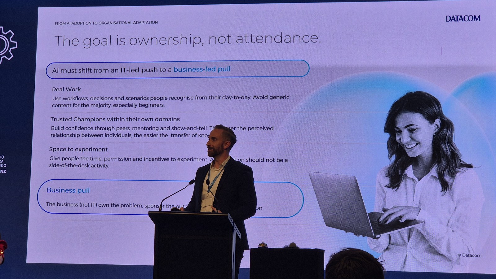 Slide headed The goal is ownership, not attendance, arguing AI must shift from an IT-led push to a business-led pull, with sections on real work, trusted champions and space to experiment